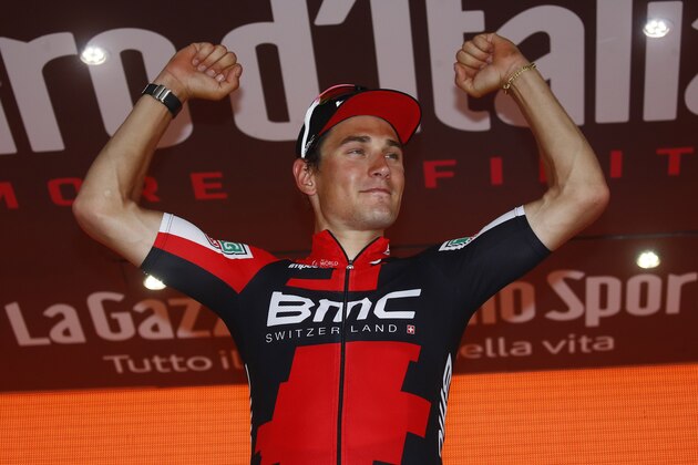 Swiss BMC rider Silvan Dillier celebrates on the podium after winning the 6th stage of the 100th Giro d'Italia, Tour of Italy, cycling race from Reggio di Calabria to Terme Luigiane on May 11, 2017. 
Luxembourg's Bob Jungels, of the Quick Step team, retained the race leader's pink jersey after a dramatic 217km ride from Reggio di Calabria to Terme Luigiane that saw the peloton fail to reel in a five-man breakaway. / AFP PHOTO / Luk BENIES        (Photo credit should read LUK BENIES/AFP/Getty Images)