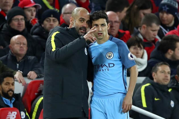 LIVERPOOL, ENGLAND - DECEMBER 31:  Jesus Navas of Manchester City speaks with Josep Guardiola, Manager of Manchester City during the Premier League match between Liverpool and Manchester City at Anfield on December 31, 2016 in Liverpool, England.  (Photo by Clive Brunskill/Getty Images)