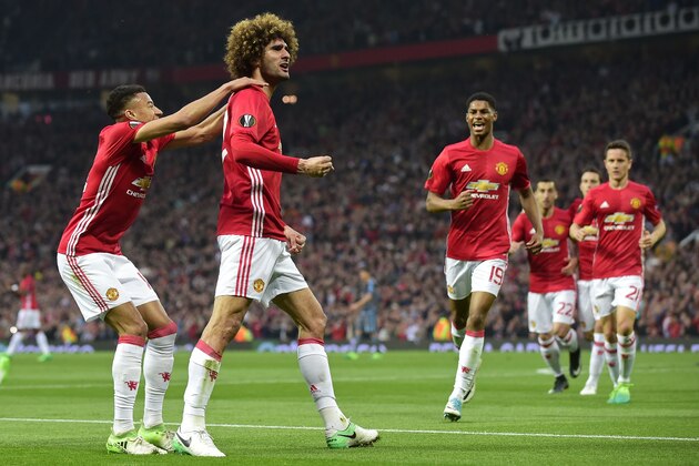 Belgian midfielder Marouane Fellaini (2nd L) celebrates with teammates after scoring the opening goal of the UEFA Europa League semi-final, second-leg football match between Manchester United and Celta Vigo at Old Trafford stadium in Manchester, north-west England, on May 11, 2017. / AFP PHOTO / Miguel RIOPA        (Photo credit should read MIGUEL RIOPA/AFP/Getty Images)