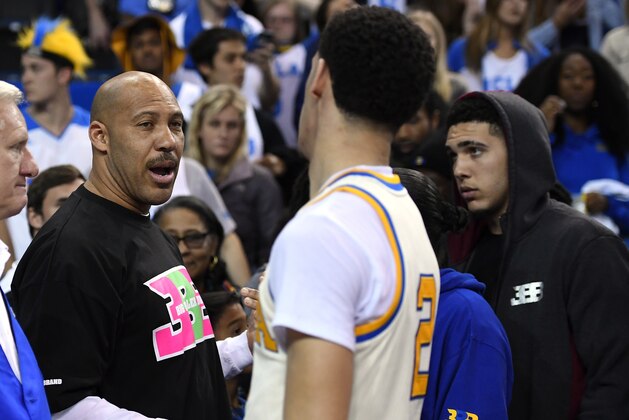 FILE - In this March 4, 2017, file photo, UCLA guard Lonzo Ball, right, shakes hands with his father LaVar following an NCAA college basketball game against Washington State in Los Angeles. UCLA won 77-68. LaVar Ball's Big Baller Brand unveiled a signature shoe for Lonzo Ball on May 4, 2017 with a price tag of $495 a pair. (AP Photo/Mark J. Terrill, File)