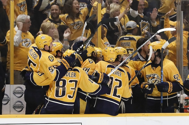 Nashville Predators players celebrate after Calle Jarnkrok, not shown, scored an empty-net goal against the St. Louis Blues during the third period in Game 6 of a second-round NHL hockey playoff series Sunday, May 7, 2017, in Nashville, Tenn. At left is Predators head coach Peter Laviolette. The Predators won 3-1 to win the series 4-2. (AP Photo/Mark Humphrey)