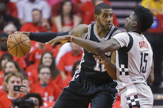 San Antonio Spurs forward LaMarcus Aldridge, left, dribbles as Houston Rockets center Clint Capela defends during the first half in Game 6 of an NBA basketball second-round playoff series, Thursday, May 11, 2017, in Houston. (AP Photo/Eric Christian Smith)