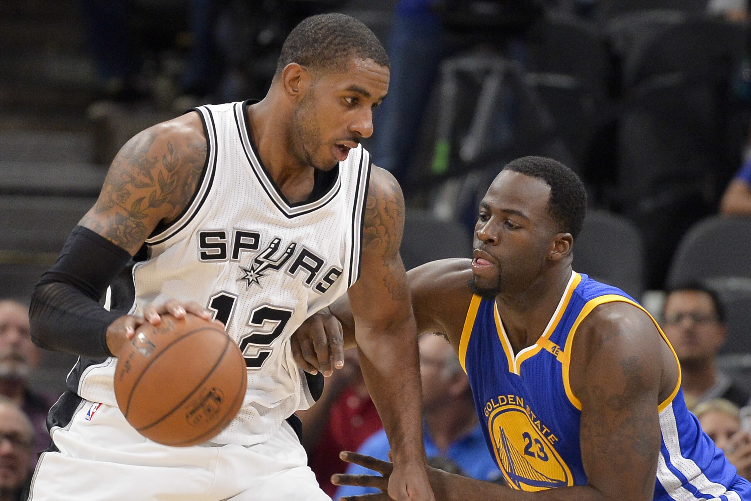 San Antonio Spurs forward LaMarcus Aldridge (12) drives against Golden State Warriors forward Draymond Green during the first half of an NBA basketball game, Wednesday, March 29, 2017, in San Antonio. Golden State won 110-98. (AP Photo/Darren Abate)