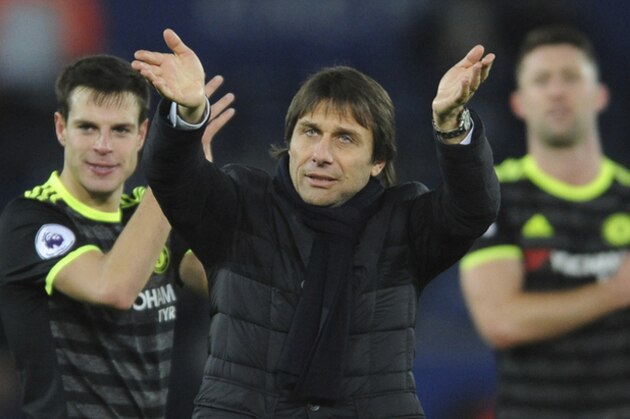 Chelsea manager Antonio Conte celebrates towards fans after the English Premier League soccer match between Leicester City and Chelsea at the King Power Stadium in Leicester, England, Saturday, Jan. 14, 2017. (AP Photo/Rui Vieira)