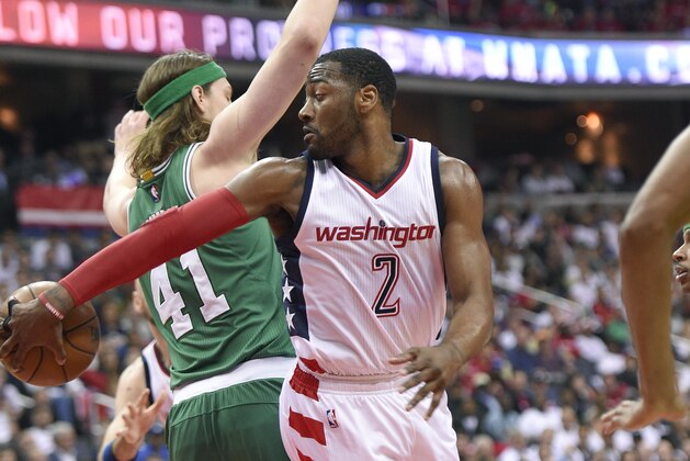 Washington Wizards guard John Wall (2) passes behind Boston Celtics center Kelly Olynyk (41), of Canada, during the first half in Game 4 of a second-round NBA basketball playoff series, Sunday, May 7, 2017, in Washington. (AP Photo/Nick Wass)