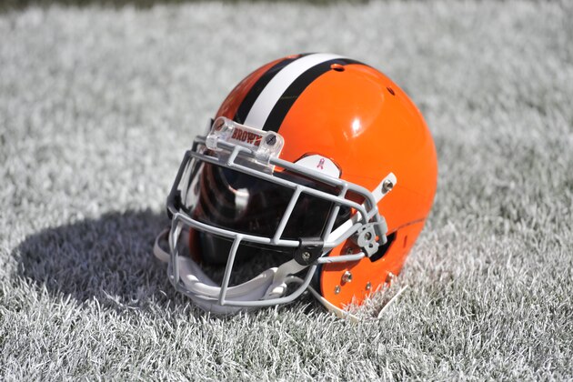 FILE - This Oct. 12, 2014, file photo shows a Cleveland Browns helmet on the field before an NFL football game between the Pittsburgh Steelers and the Browns in Cleveland. The Browns unveiled a new primary logo, Tuesday, Feb. 24, 2015, and it's not much different than the old one. The only NFL team without a logo decal on its helmet, Cleveland's main logo remains its iconic helmet though with a brighter orange and a brown facemask. (AP Photo/David Richard, File)