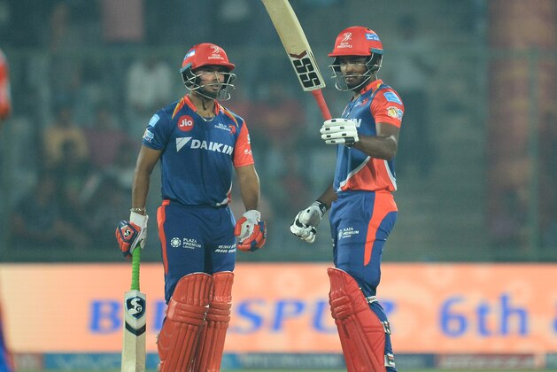 Delhi Daredevils batsman Sanju Samson (R) raises his bat after he completes his half century (50 runs) as team batsman Rishabh Pant looks on during the 2017 Indian Premier League (IPL) Twenty20 cricket match between Delhi Daredevils and Gujarat Lions at the Feroz Shah Kotla Cricket Stadium in New Delhi on May 4,2017.  / AFP PHOTO / SAJJAD HUSSAIN        (Photo credit should read SAJJAD HUSSAIN/AFP/Getty Images)
