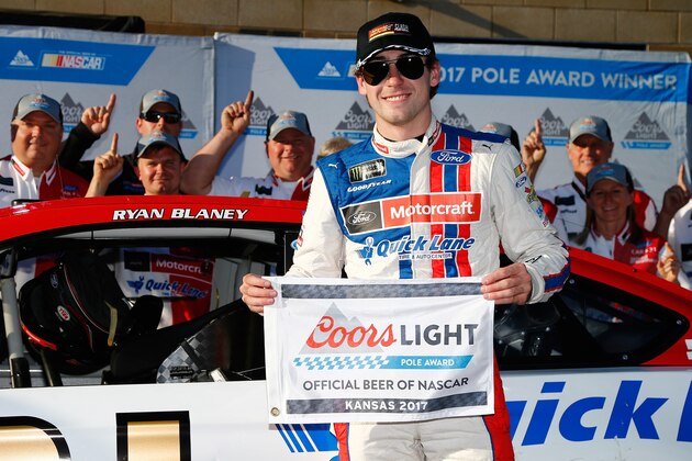 KANSAS CITY, KS - MAY 12:  Ryan Blaney, driver of the #21 Motorcraft/Quick Lane Tire & Auto Center Ford, poses for a photo after winning the pole award for the Monster Energy NASCAR Cup Series Go Bowling 400 at Kansas Speedway on May 12, 2017 in Kansas City, Kansas.  (Photo by Sean Gardner/Getty Images)