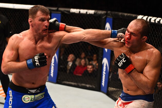 PHOENIX, AZ - DECEMBER 13:  (R-L) Junior Dos Santos of Brazil and Stipe Miocic trade punches in their heavyweight fight during the UFC Fight Night event at the U.S. Airways Center on December 13, 2014 in Phoenix, Arizona.  (Photo by Josh Hedges/Zuffa LLC/Zuffa LLC via Getty Images)