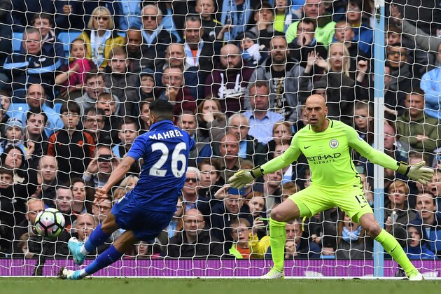 Manchester City's Argentinian goalkeeper Willy Caballero (R) stands by as Leicester City's Algerian midfielder Riyad Mahrez (L) takes his penalty, which hit his standing foot on the way to the goal, and was subsequently disallowed during the English Premier League football match between Manchester City and Leicester City at the Etihad Stadium in Manchester, north west England, on May 13, 2017. / AFP PHOTO / Paul ELLIS / RESTRICTED TO EDITORIAL USE. No use with unauthorized audio, video, data, fixture lists, club/league logos or 'live' services. Online in-match use limited to 75 images, no video emulation. No use in betting, games or single club/league/player publications.  /         (Photo credit should read PAUL ELLIS/AFP/Getty Images)