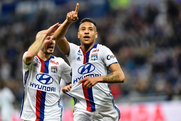 Lyon's French midfielder Corentin Tolisso (R) celebrates after scoring a goal with Lyon's French defender Christophe Jallet (L) during the French L1 football match between Olympique Lyonnais (OL) and Lorient (FCL) on April 8, 2017, at the Parc Olympique Lyonnais stadium in Decines-Charpieu near Lyon, central-eastern France.  / AFP PHOTO / ROMAIN LAFABREGUE        (Photo credit should read ROMAIN LAFABREGUE/AFP/Getty Images)