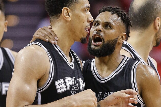 San Antonio Spurs guard Patty Mills (8) talks with guard Danny Green after Green was called for a technical foul during the second half in Game 6 of the team's NBA basketball second-round playoff series against the Houston Rockets, Thursday, May 11, 2017, in Houston. San Antonio won 114-75. (AP Photo/Eric Christian Smith)