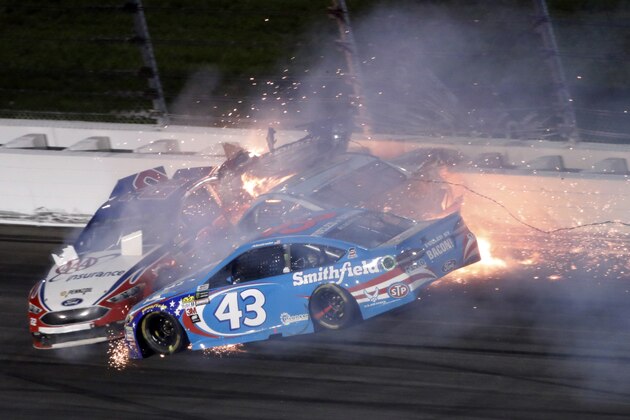 Aric Almirola (43) crashes into Danica Patrick and Joey Logano (22) during the NASCAR Monster Cup auto race at Kansas Speedway in Kansas City, Kan., Saturday, May 13, 2017. (AP Photo/Colin E. Braley)