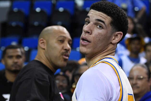 UCLA guard Lonzo Ball, right, walks away after hugging his father, LaVar, following the team's NCAA college basketball game against Washington State, Saturday, March 4, 2017, in Los Angeles. UCLA won 77-68. (AP Photo/Mark J. Terrill)