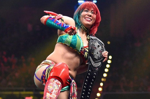 Asuka celebrating with her NXT Women's Championship.