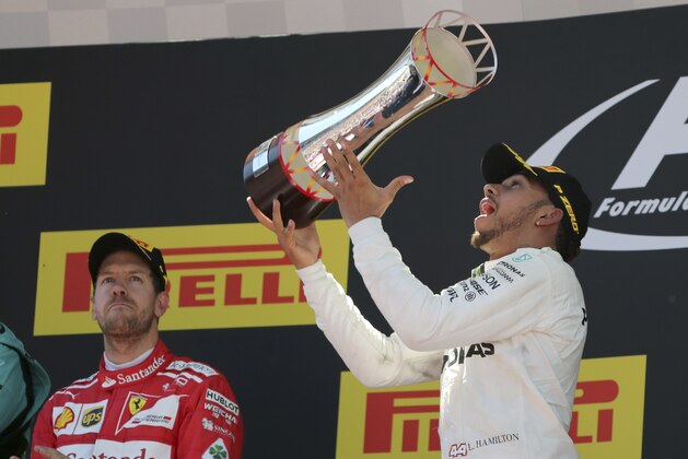 Mercedes driver Lewis Hamilton of Britain celebrates on the podium after winning the Spanish Formula One Grand Prix at the Barcelona Catalunya racetrack in Montmelo, Spain, Sunday, May 14, 2017. (AP Photo/Emilio Morenatti)