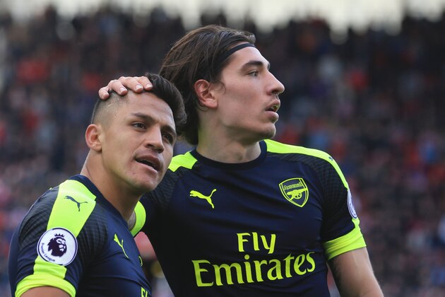 Arsenal's Chilean striker Alexis Sanchez celebrates with Arsenal's Spanish defender Hector Bellerin (R) after scoring their third goal during the English Premier League football match between Stoke City and Arsenal at the Bet365 Stadium in Stoke-on-Trent, central England on May 13, 2017.
Arsenal won the game 4-1. / AFP PHOTO / Lindsey PARNABY / RESTRICTED TO EDITORIAL USE. No use with unauthorized audio, video, data, fixture lists, club/league logos or 'live' services. Online in-match use limited to 75 images, no video emulation. No use in betting, games or single club/league/player publications.  /         (Photo credit should read LINDSEY PARNABY/AFP/Getty Images)