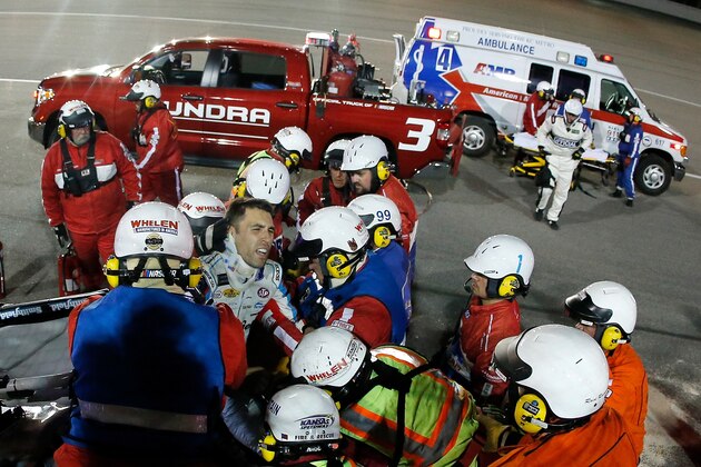 KANSAS CITY, KS - MAY 13:  Safety crew workers place Aric Almirola, driver of the #43 Smithfield Ford, on a stretcher after cutting off the roof of his car after a crash during the Monster Energy NASCAR Cup Series Go Bowling 400 at Kansas Speedway on May 13, 2017 in Kansas City, Kansas.  (Photo by Sean Gardner/Getty Images)