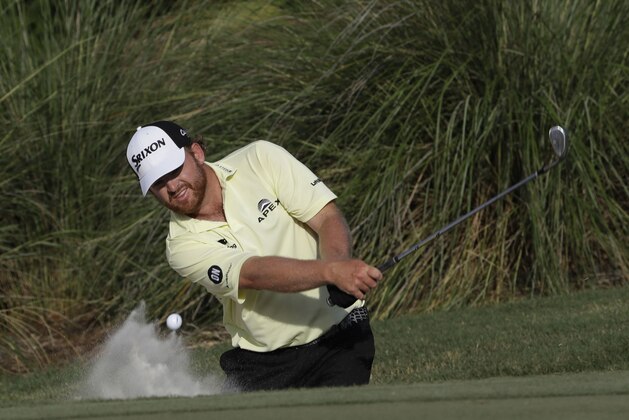 J. B. Holmes hits from the sand onto the 14th green during the third round of The Players Championship golf tournament Saturday, May 13, 2017, in Ponte Vedra Beach, Fla. (AP Photo/Chris O'Meara)