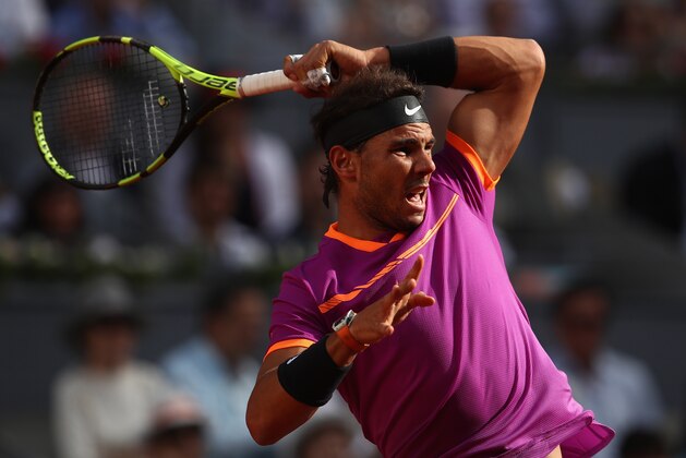 MADRID, SPAIN - MAY 14:  Rafael Nadal of Spain in action against Dominic Thiem of Austria in the final during day nine of the Mutua Madrid Open tennis at La Caja Magica on May 14, 2017 in Madrid, Spain.  (Photo by Julian Finney/Getty Images)