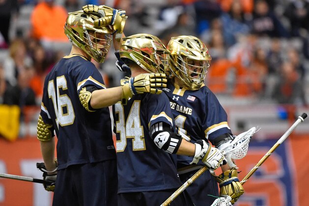 SYRACUSE, NY - APRIL 02:  Ryder Garnsey (R) of the Notre Dame Fighting Irish celebrates his goal with teammates Trevor Brosco #34 and Sergio Perkovic #16 against the Syracuse Orange during the third quarter at the Carrier Dome on April 2, 2016 in Syracuse, New York.  Notre Dame defeated Syracuse 17-7.  (Photo by Rich Barnes/Getty Images)