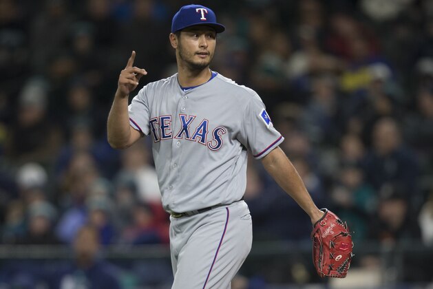 SEATTLE, WA - MAY 5: Starting pitcher Yu Darvish #11 of the Texas Rangers gestures to the dugout while walking back to the pitcher's mound during a game against the Seattle Mariners at Safeco Field on May 5, 2017 in Seattle, Washington. The Rangers won the game 3-1 in 13 innings. (Photo by Stephen Brashear/Getty Images)