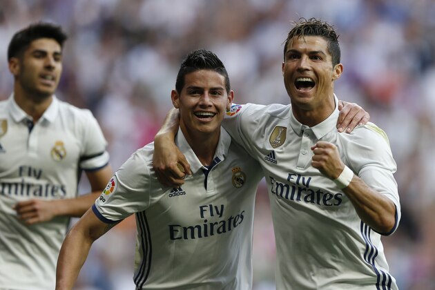 Real Madrid's Cristiano Ronaldo, right, celebrates with teammate James Rodriguez after scoring their side's second goal against Sevilla during the La Liga soccer match between Real Madrid and Sevilla at the Santiago Bernabeu stadium in Madrid, Sunday, May 14, 2017. (AP Photo/Francisco Seco)