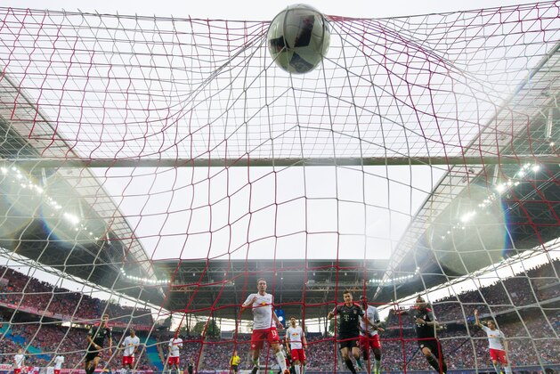Munich´s Polish forward Robert Lewandowski scores the third goal for his team during the German first division Bundesliga football match between RB Leipzig and FC Bayern Munich in Leipzig, eastern Germany on May 13, 2017.  / AFP PHOTO / ROBERT MICHAEL / RESTRICTIONS: DURING MATCH TIME: DFL RULES TO LIMIT THE ONLINE USAGE TO 15 PICTURES PER MATCH AND FORBID IMAGE SEQUENCES TO SIMULATE VIDEO. == RESTRICTED TO EDITORIAL USE == FOR FURTHER QUERIES PLEASE CONTACT DFL DIRECTLY AT + 49 69 650050
        (Photo credit should read ROBERT MICHAEL/AFP/Getty Images)
