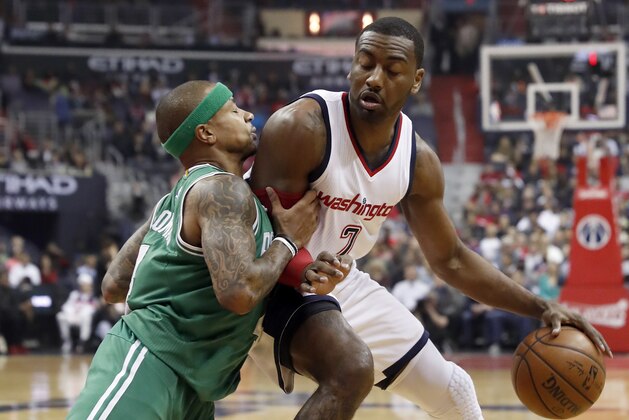 Boston Celtics guard Isaiah Thomas, left, pushes against Washington Wizards guard John Wall during the first half of Game 6 of an NBA basketball second-round playoff series, Friday, May 12, 2017, in Washington. (AP Photo/Alex Brandon)