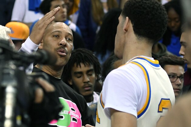 UCLA guard Lonzo Ball, right, shakes hands with his father LaVar following an NCAA college basketball game against Washington State, Saturday, March 4, 2017, in Los Angeles. UCLA won 77-68. (AP Photo/Mark J. Terrill)