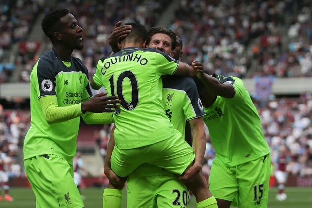 Liverpool's Brazilian midfielder Philippe Coutinho (CL), Liverpool's English midfielder Adam Lallana (CR) and teammates celebrate their third goal during the English Premier League football match between West Ham United and Liverpool at The London Stadium, in east London on May 14, 2017. / AFP PHOTO / Daniel LEAL-OLIVAS / RESTRICTED TO EDITORIAL USE. No use with unauthorized audio, video, data, fixture lists, club/league logos or 'live' services. Online in-match use limited to 75 images, no video emulation. No use in betting, games or single club/league/player publications.  /         (Photo credit should read DANIEL LEAL-OLIVAS/AFP/Getty Images)