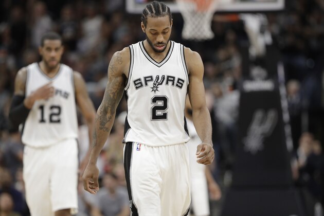 San Antonio Spurs forward Kawhi Leonard (2) and forward LaMarcus Aldridge (12) walk uproot during the second half of Game 5 in a second-round NBA basketball playoff series against the Houston Rockets, Tuesday, May 9, 2017, in San Antonio. (AP Photo/Eric Gay)
