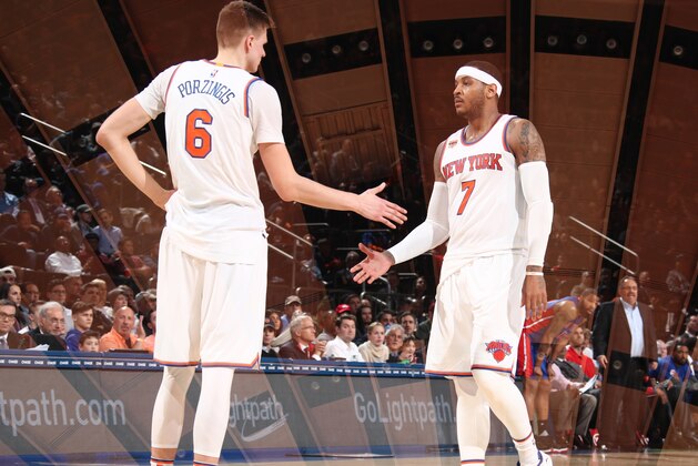NEW YORK, NY - MARCH 27: (EDITORS NOTE: Multiple exposures were combined in camera to produce this image.) Kristaps Porzingis #6 and Carmelo Anthony #7 of the New York Knicks celebrate during a game against the Detroit Pistons on March 27, 2017 at Madison Square Garden in New York City, New York. NOTE TO USER: User expressly acknowledges and agrees that, by downloading and/or using this photograph, user is consenting to the terms and conditions of the Getty Images License Agreement. Mandatory Copyright Notice: Copyright 2017 NBAE (Photo by Nathaniel S. Butler/NBAE via Getty Images)