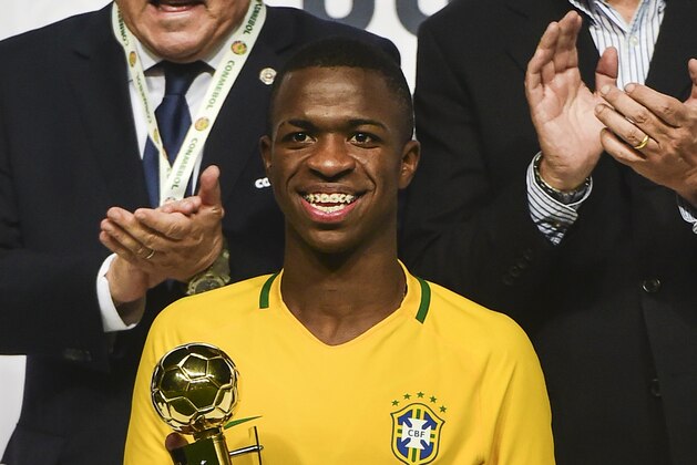 Brazil´s  Vinicius Junior poses with the best player trophy in the South American U-17 football tournament in Rancagua, some 90 km south of Santiago de Chile on March 19, 2017. / AFP PHOTO / MARTIN BERNETTI        (Photo credit should read MARTIN BERNETTI/AFP/Getty Images)
