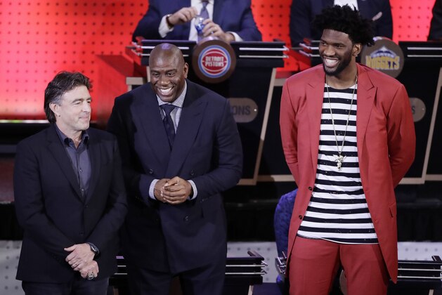 Boston Celtics co-owner Wyc Grousbeck, left, Magic Johnson, president of basketball operations for the Los Angeles Lakers, center , and Philadelphia 76ers' Joel Embiid, right, react after the learning they will get one of the first three picks as the NBA basketball draft lottery is announced, Tuesday, May 16, 2017, in New York. (AP Photo/Frank Franklin II)