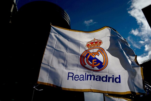 MADRID, SPAIN - JANUARY 31: A Real madrid flag flutters displayed at a merchandaising stall at Estadio Santiago Bernabeu outdoors before the La Liga match between Real Madrid CF and Real Sociedad de Futbol  on January 31, 2015 in Madrid, Spain.  (Photo by Gonzalo Arroyo Moreno/Getty Images)