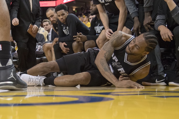May 14, 2017; Oakland, CA, USA; San Antonio Spurs forward Kawhi Leonard (2) reacts after an injury during the third quarter in game one of the Western conference finals of the 2017 NBA Playoffs against the Golden State Warriors at Oracle Arena. The Warriors defeated the Spurs 113-111. Mandatory Credit: Kyle Terada-USA TODAY Sports