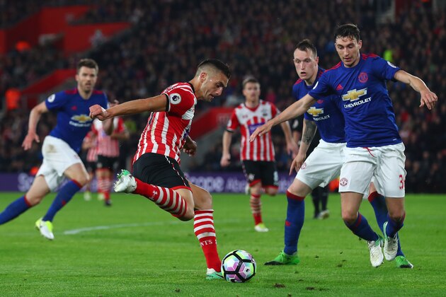 SOUTHAMPTON, ENGLAND - MAY 17: Dusan Tadic of Southampton shoots as Matteo Darmian of Manchester United attempts to block during the Premier League match between Southampton and Manchester United at St Mary's Stadium on May 17, 2017 in Southampton, England.  (Photo by Clive Rose/Getty Images)