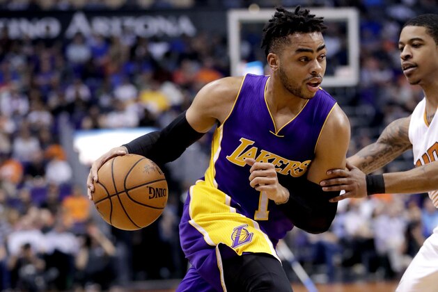 Los Angeles Lakers guard D'Angelo Russell (1) drives past Phoenix Suns guard Tyler Ulis during the first half of an NBA basketball game, Thursday, March 9, 2017, in Phoenix. (AP Photo/Matt York)