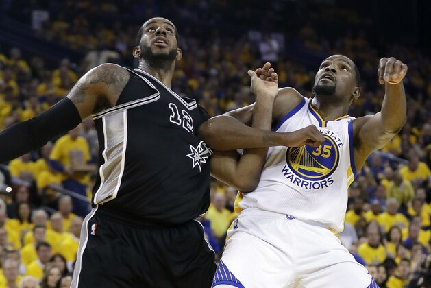San Antonio Spurs' LaMarcus Aldridge (12) and Golden State Warriors' Kevin Durant (35) work for position under the basket during the second half of Game 2 of the NBA basketball Western Conference finals, Tuesday, May 16, 2017, in Oakland, Calif. (AP Photo/Marcio Jose Sanchez)