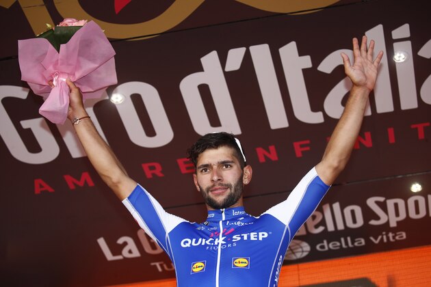 Colombia's Fernando Gaviria of team Quick-Step celebrates on the podium after winning the 5th stage of the 100th Giro d'Italia, Tour of Italy, cycling race from Pedara to Messina on May 10, 2017 in Sicily. 
Gaviria, of the Quick Step team, had taken the race lead by winning Sunday's third stage and achieved his second success in a sprint at the finish of the 159km ride from Pedara to Messina, Sicily. / AFP PHOTO / Luk BENIES        (Photo credit should read LUK BENIES/AFP/Getty Images)