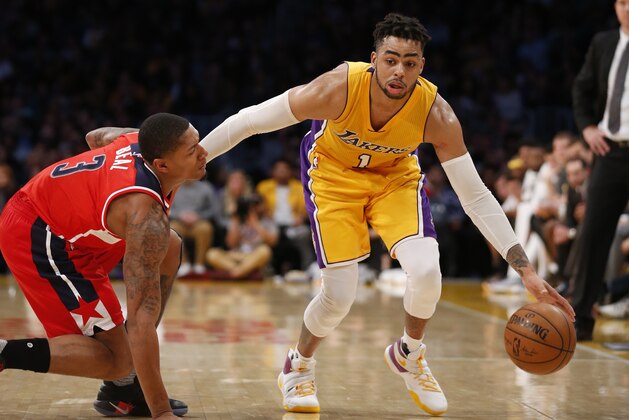 Los Angeles Lakers guard D'Angelo Russell controls the ball while Washington Wizards guard Bradley Beal, left, defends him during the second half of an NBA basketball game, Tuesday, March 28, 2017, in Los Angeles. The Wizards won 119-108. (AP Photo/Danny Moloshok)