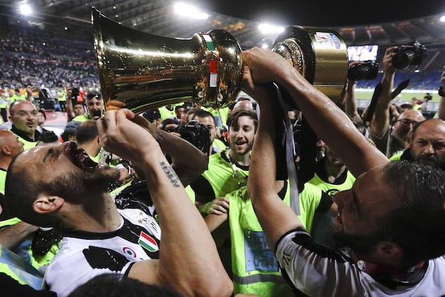 Juventus' Leonardo Bonucci drinks from the trophy after winning the Italian Cup soccer final match between Lazio and Juventus, at Rome's Olympic stadium, Wednesday, May 17, 2017. Juventus won 2-0. (AP Photo/Gregorio Borgia)