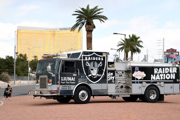 LAS VEGAS, NV - MARCH 27:  Oakland Raiders fan Nelson Aburto of California takes photos of a fire engine emblazoned with Raiders logos near the Welcome to Fabulous Las Vegas sign after National Football League owners voted 31-1 to approve the team's application to relocate to Las Vegas during their annual meeting on March 27, 2017 in Las Vegas, Nevada. The Raiders are expected to begin play no later than 2020 in a planned 65,000-seat domed stadium to be built in Las Vegas at a cost of about USD 1.9 billion.  (Photo by Ethan Miller/Getty Images)