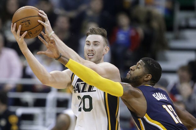 Indiana Pacers forward Paul George (13) attempts to steal the ball from Utah Jazz forward Gordon Hayward (20) during the second half of an NBA  basketball game Saturday, Dec. 5, 2015, in Salt Lake City. Utah won 122-119 in overtime. (AP Photo/Rick Bowmer)
