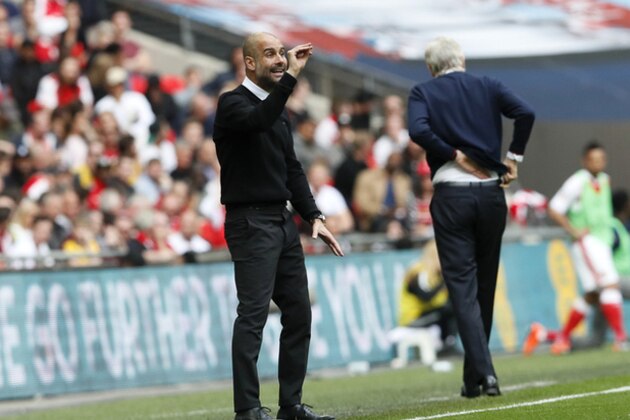 Manchester City manager Pep Guardiola gestures next to Arsenal team manager Arsene Wenger, right, during the English FA Cup semifinal soccer match between Arsenal and Manchester City at Wembley stadium in London, Sunday, April 23, 2017. (AP Photo/Kirsty Wigglesworth)