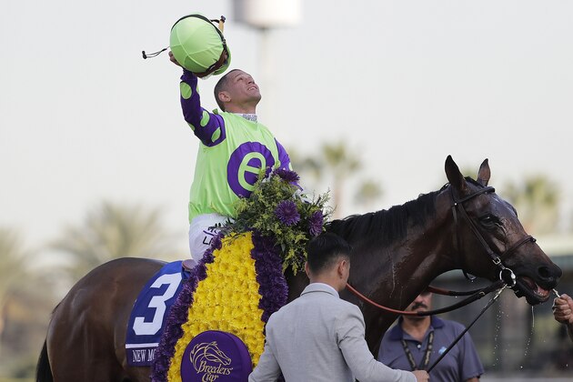 Jockey Javier Castellano celebrates after riding New Money Honey to victory in the Breeders' Cup Juvenile Fillies Turf horse race at Santa Anita, Friday, Nov. 4, 2016, in Arcadia, Calif. (AP Photo/Jae C. Hong)