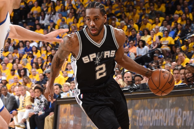 OAKLAND, CA - MAY 14: Kawhi Leonard #2 of the San Antonio Spurs handles the ball against the Golden State Warriors in Game One of the Western Conference Finals of the 2017 NBA Playoffs on May 14, 2017 at ORACLE Arena in Oakland, California. NOTE TO USER: User expressly acknowledges and agrees that, by downloading and/or using this Photograph, user is consenting to the terms and conditions of the Getty Images License Agreement. Mandatory Copyright Notice: Copyright 2017 NBAE (Photo by Andrew D. Bernstein/NBAE via Getty Images)