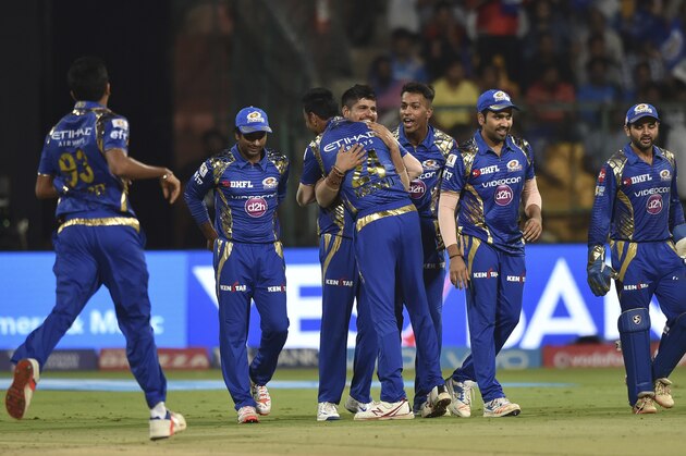 Mumbai Indians Karn Sharma, centre, celebrates the wicket of Colin De Grandhomme of Kolkata Knight Riders with his team players during the Indian Premier League cricket eliminator match in Bangalore, India, Friday, May 19, 2017. (AP Photo)
