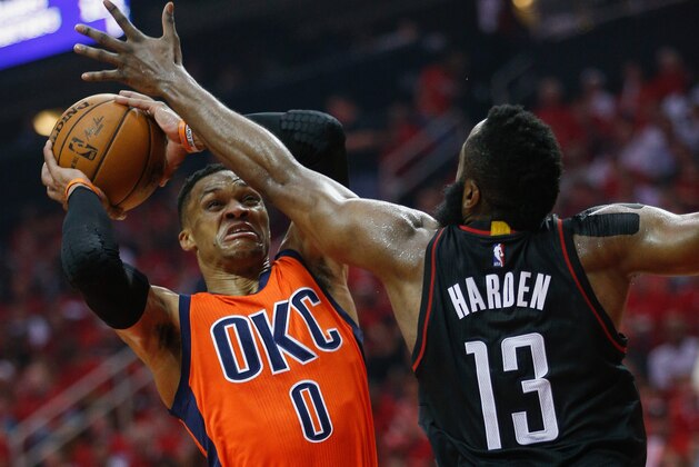 HOUSTON, TX - APRIL 16:  Russell Westbrook #0 of the Oklahoma City Thunder drives to the basket as James Harden #13 of the Houston Rockets defends during Game One of the first round of the Western Conference 2017 NBA Playoffs at Toyota Center on April 16, 2017 in Houston, Texas. NOTE TO USER: User expressly acknowledges and agrees that, by downloading and/or using this photograph, user is consenting to the terms and conditions of the Getty Images License Agreement.  (Photo by Bob Levey/Getty Images)